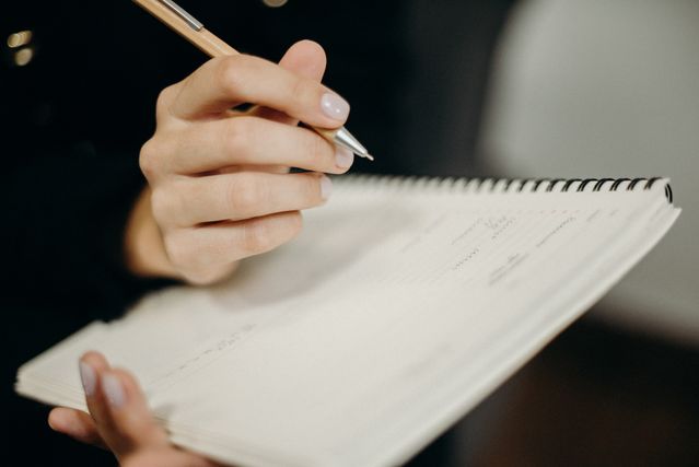 a person writing in a notebook